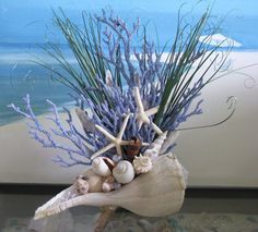 a vase filled with sea shells and starfish