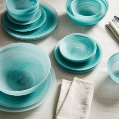 a table topped with blue plates and silverware