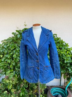 Vintage 1970's denim blazer jacket by Land Lubber. Buttons down the front with hand pockets at the hips.  Fitted style with a back center vent.  Epaulettes with buttons at the shoulders.  Great vintage condition!  The buttons have lost color.  See pictures. label: The Original and Authentic Landlubber fabric:  feels like all cotton with no stretch size:  no size listed.  Extra small is just an estimate. Please check measurements for an accurate fit.  Questions are welcome!  For reference, my dress form measures 36x24x35 and it was a nice fit. jacket was measured across the front side lying flat underarm to underarm 18" waist 15" length 28" shoulder 15" sleeve from shoulder seam 24 1/2" Vintage Single Breasted Denim Jacket For Work, Vintage Single-breasted Denim Jacket For Work, Vintage Single Breasted Denim Jacket For Fall, Vintage Button-up Cotton Blazer, Vintage Cotton Blazer With Button Closure, Vintage Cotton Blazer With Buttons, Vintage Medium Wash Single Breasted Denim Jacket, Vintage Single Breasted Medium Wash Denim Jacket, Retro Cotton Blazer With Button Closure