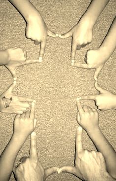 several people are holding their hands in the shape of a star, making a circle