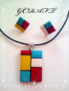 a necklace and earring set made out of colorful blocks on a black cord with sparkles in the background