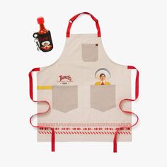 an apron with two pockets and a bottle of ketchup next to it