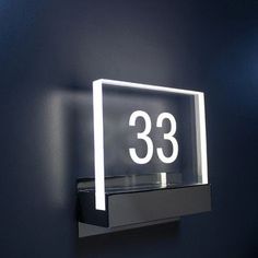 an illuminated sign on the wall that reads'33'in white and black lettering