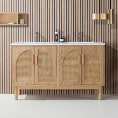 a wooden cabinet with two sinks in front of a striped wall