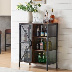 a shelf with liquor bottles and glasses on it