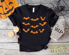 Halloween Bats Shirt, Aesthetic Bats Shirt, Bat Lover Gift For Halloween, Creepy Bats TShirt Women, Spooky Bats Shirt, Halloween Party Tee ----- How To Order ----- 1-) Please, check and review all the photos. 2-) Choose your t-shirt size and color. *Different styles of shirts may have different shades of same color choice due to different manufacturer brands. *For this reason, we recommend you to match shirts from the same styles if you want precisely matching colors (ex. Unisex, V-necks, Toddler, etc.). 3-) Click add to cart. You can go back to add more shirts. 4-)Click "Proceed to check out". 5-)When you check out, you can add a note to seller for any request. ----- Unisex Shirts ----- * Unisex t shirt fits like a well-loved favorite, featuring a crew neck, short sleeves and designed wit Black Halloween Top With Funny Print, Black Funny Print Top For Halloween, Fun Black Top For Halloween, Fun Black Tops For Halloween, Black Novelty Top With Custom Print, Black Novelty Crew Neck Shirt, Black Crew Neck Novelty Shirt, Black Themed Long Sleeve T-shirt, Bat Shirt