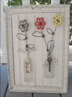 an old frame is decorated with flowers and mason jars as the centerpiece for this art project