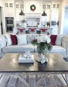 a living room filled with furniture next to a christmas wreath on top of a table