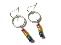 "Love these gorgeous colorful rainbow bead earrings! One of a kind earrings! They will go with so many outfits and make a beautiful statement! These earrings dangle about 2\" long and lightweight. I can make more of these earrings if you need more pairs. Just message me! A great gift for that special someone who has everything! Check out my other mixed metal earrings! https://www.etsy.com/shop/HeidiKindFinds?ref=hdr_shop_menu&search_query=mixed+metal+earrings" Nickel-free Round Rainbow Beaded Earrings, Trendy Rainbow Jewelry For Pride, Rainbow Nickel-free Dangle Hoop Earrings, Nickel-free Rainbow Dangle Hoop Earrings, Nickel-free Rainbow Round Beaded Earrings, Rainbow Beaded Dangle Hoop Earrings, Rainbow Dangle Hoop Earrings, Nickel-free Rainbow Round Bead Jewelry, Nickel-free Rainbow Round Beaded Jewelry