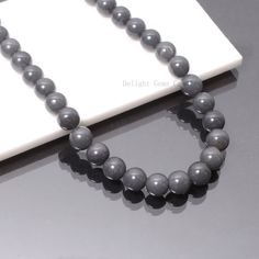 "Product Details : Item Code : DGC3672 Gemstone Name : GREY QUARTZ Chain Style : BEADED Beads Shape : SMOOTH ROUND Beads Size : 10 MM Approx. Length : 18\" Inch Approx. Weight : 320 Cts. Approx. Customization : **Available** Please Feel Free To Contact If You Have Any Query." Grey Beads Necklace, Adjustable Gray Necklace With Gemstone Beads, Adjustable Gray Gemstone Beads Necklace, Adjustable Gray Gemstone Beaded Necklace, Gray Gemstone Beads Necklaces For Gifts, Gray Gemstone Beads Necklace For Gift, Gray Single Strand Round Bead Jewelry, Gray Single Strand Jewelry With Round Beads, Gray Round Spacer Beads Jewelry