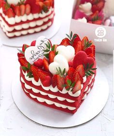 two heart shaped cakes with strawberries on top