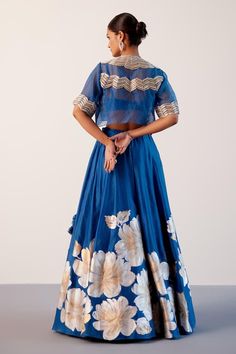 Blue silk chanderi lehenga detailed with gold and silver daisy bloom hand paint. Paired with a singlet silk chanderi blouse and a zari embroidered sheer organza short jacket. - Aza Fashions Festive Silk Lehenga For Celebration, Festive Cotton Silk Lehenga With Dori Work, Reception Cotton Silk Lehenga With Dori Work, Cotton Silk Lehenga With Dori Work For Reception, Transitional Cotton Silk Lehenga With Dori Work, Cotton Silk Sets With Gota Work For Reception, Blue Tissue Silk Sets With Dori Work, Blue Cotton Silk Dupatta For Reception, Silk Lehenga For Navratri Celebration