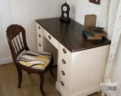 a chair sitting next to a desk with a clock on it