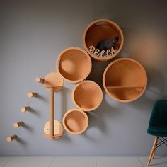 a wall mounted shelf with wooden bowls and spoons