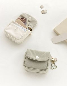 Secure your belongings with a snap! The Piyo Snap Mini Pouch is a compact size pouch that can hold cards, coins, bills, cosmetics and more. It’s the perfect size to fi... Beige Bag With Coin Pocket For Daily Use, Beige Travel Coin Purse With Coin Pocket, Compact Beige Bags With Card Slots, Compact Beige Bag With Card Slots, Beige Everyday Coin Purse, Trendy Coin Purse With Removable Pouch For Daily Use, Daily Use Compact Bags With Coin Pocket, Beige Travel Bag With Coin Pocket, Compact Beige Coin Purse For Daily Use