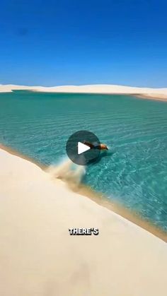 there is a video playing on the beach with sand and water in the foreground