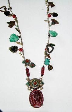 "Popular in the 1970s, this is a \"charm necklace\" Attached to either side of the chain are the same charms or in many instances, different charms.  Charms are set with RS and crystals, are enameled, are semi precious stones, are single prong set RS, beads etc. The pendant is hung from a partially enameled connector set with crystals and a semi precious stone. The pendant is a molded glass cameo. Measures:  Chain - 28\" long  Entire pendant - 3 1/4\" by 1 1/2\"" Vintage Charm Pendant Necklace, Vintage Dangle Necklaces For Jewelry Making, Vintage Pendant Necklaces With Dangling Charms, Vintage Dangle Chain Necklace For Gift, Vintage Jeweled Chain Necklace As A Gift, Vintage Dangle Chain Necklace As Gift, Vintage Jeweled Chain Necklace Gift, Vintage Jewel Chain Necklace As Gift, Vintage Jewel Chain Necklace For Gift