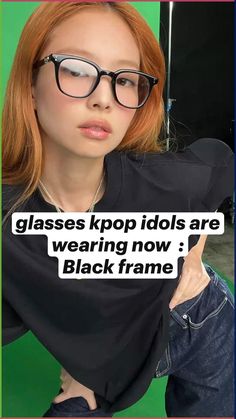 a woman with glasses holding up a sign that says glasses kpop idols are wearing now black frame