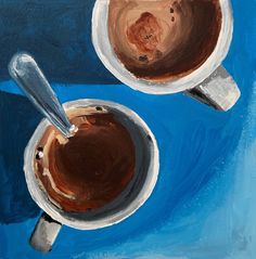 two cups of coffee with spoons are on a blue tablecloth, one is painted in acrylic