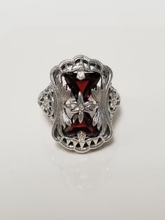 "Thanks for shopping our vintage estate store. We tend to sell well below wholesale and truly hope you enjoy all of our items. Many of the items are one of a kind, so please enjoy scrolling through the pictures and hopefully something will catch your eye. Estate sterling silver 925 natural 1ct garnet trillion cut filigree ring. Beautiful ring, one that was custom made in our shop, meaning we set the gems into the setting. Love this victorian style ring. Ring size: please select Setting: 5/8\" by 3/4\" 9mm Band width: 1.5mm Weight: 6.22 grams Beautiful ring one that you will love. Gems testing natural, but maybe created." Vintage Gothic Wedding Rings, Classic Jewelry For Valentine's Day, Classic Silver Ruby Ring For Valentine's Day, Vintage Ring Jewelry For Valentine's Day, Vintage Silver Filigree Ring, Estate Silver Oval Jewelry, Vintage Hallmarked White Gold Ruby Ring, Vintage White Gold Filigree Ring, Hallmarked Vintage White Gold Ruby Ring