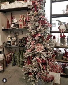 a christmas tree is decorated with red and white ribbon