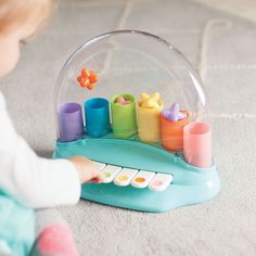 a child playing with a toy set on the floor