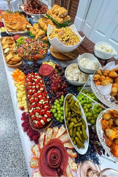 a table filled with lots of different types of food and desserts on top of it