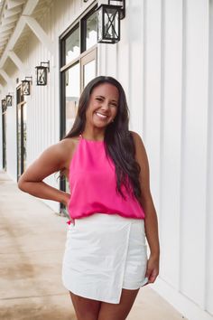 We are loving this pretty top in a hot pink color, featuring a halter style neckline, t strap back with pearls adorning the straps, fully lined and side slits. This top would be perfect paired with a white skort or white jeans!! Shell & Lining - 97% Polyester, 3%spandex Runs true to size! Model has a 34" bust and a 26" waist wearing a size small. White Skort, Pretty Top, Cowl Neck Top, Taupe Color, Halter Style, T Strap, Cami Top