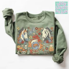 Western Halloween Sweatshirt Cowgirl Halloween Shirts Halloween Shirt Retro Halloween Doodles Sweatshirt Halloween Crewnecks Spooky Season Aesthetic Sweatshirts Gothic Clothing This soft sweatshirt has a loose fit for a comfortable feel. With durable print, it will be a walking billboard for years to come.   -Loose fit -50% Cotton; 50% Polyester (fibre content may vary for different colors) -Unisex - Fits true to size (see size chart for reference) -Printed with ink direct to garment for a long Fall Goblincore Crew Neck T-shirt, Green Halloween Graphic Print Sweatshirt, Fall Character Print Relaxed Fit Sweatshirt, Halloween Cartoon Print Relaxed Fit Tops, Halloween Goblincore Crew Neck Top, Goblincore Crew Neck T-shirt For Fall, Goblincore Long Sleeve Tops For Fall, Long Sleeve Goblincore Tops For Fall, Spooky Funny Print Tops For Fall