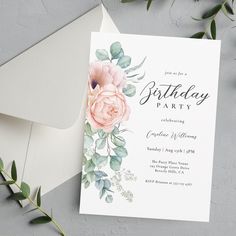 a birthday party card with pink flowers and greenery on the front, next to an envelope