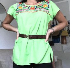 Beautiful vintage embroidered green, floral, Mexican blouse. The Mexican top is a beautiful green with brightly embroidered flowers on the front and back of the shirt.The blouse is lightweight and comfortable, perfect for the summer. It is made of 80% cotton and 20% polyester. The top is made in Mexico El Rebezo and is a size small.Please note a faint stain in the images and leather belt in not included.All items sold As Is. Any questions or concerns please contact me. Spring Embroidered Green Blouse, Summer Green Blouse With Crew Neck, Green Crew Neck Blouse For Summer, Green Cotton Top With Floral Embroidery, Green Embroidered Crew Neck Blouse, Green Crew Neck Blouse For Spring, Casual Green Blouse With Floral Embroidery, Green Crew Neck Blouse For Vacation, Green Embroidered Spring Tops