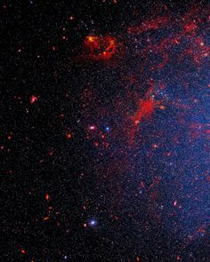 an image of a very large star in the sky with red and blue stars around it