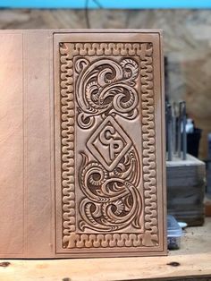 an intricately carved book sitting on top of a wooden table next to other items