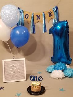 a first birthday party with balloons and decorations