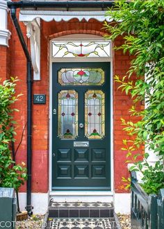 a green front door with stained glass windows