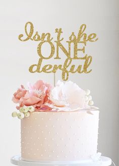 there is a cake that has some flowers on it and the words sophiia onederf