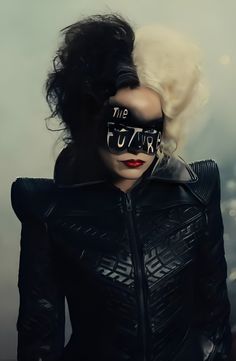 a woman with her face painted black and wearing a mask that says the future is female