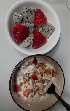 a bowl of yogurt with strawberries and kiwis on the side