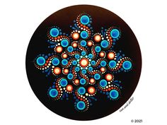 an abstract painting on a black plate with blue and orange dots in the center, surrounded by smaller circles