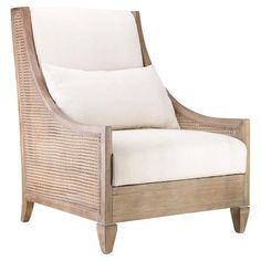 the arm chair is made from wicker and has white cushions on top of it