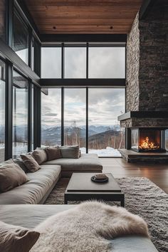 a living room filled with lots of furniture and a fire place in the middle of it