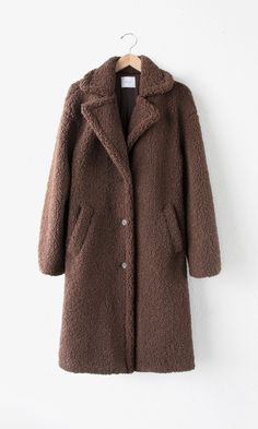 Stay warm and snuggly this winter with this Rowan Teddy Shearling Coat. Its extra-long silhouette, made of high-quality faux shearling, provides exceptional softness and comfort. Coat Faux fur Collared Button front Pockets Lined Length: 41" Chest: 20 1/2" Self: 100% Polyester Lining: 100% Polyester Hand wash in cold water with similar colors. Model is wearing a size small Style #: G238J1613 Long Grey Coat, Woolen Coat Woman, Biker Shorts Outfit, Long Faux Fur Coat, Plush Coat, Long Coat Women, Traje Casual, Teddy Coat, Sleeves Clothing