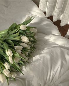 a bunch of flowers laying on top of a bed