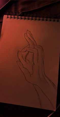 a drawing of a hand holding something in it's right hand on a piece of paper