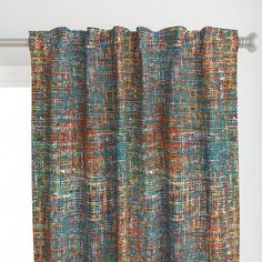 a window with a curtain made out of multicolored yarns on the outside