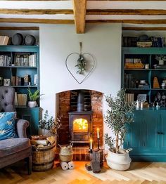 a living room filled with furniture and a fire place next to a book shelf full of books