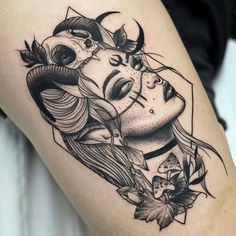 a woman's face with horns and flowers on her thigh