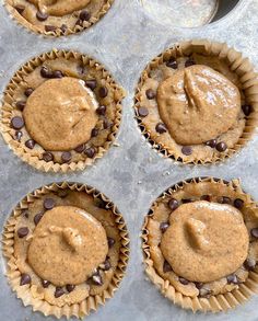 six cupcakes with peanut butter and chocolate chips in the middle, ready to be baked