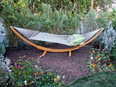 a hammock in the middle of a garden