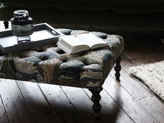 a book is sitting on top of an ottoman